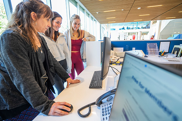Librarian helping students