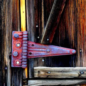 colorful hinge on an old wooden door