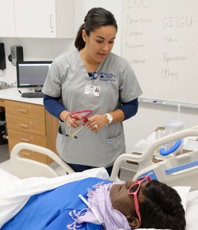Nursing students working with a manaquin