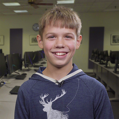 13 year old stlcc student gavin in a computer lab