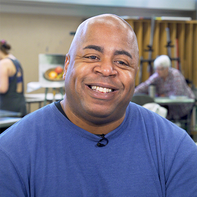 art professor sean frye in the wildwood art studio with students working behind him