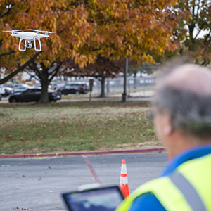 Unmanned aircraft systems training with a student flying a drone outdoors