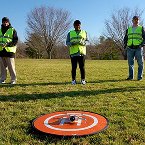 Drone pilot students preparing equipment as part of remote pilot certificate training