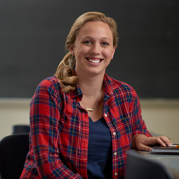 Student in the classroom sitting in front of chalkboard