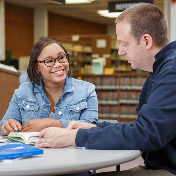 female student and male professor in library