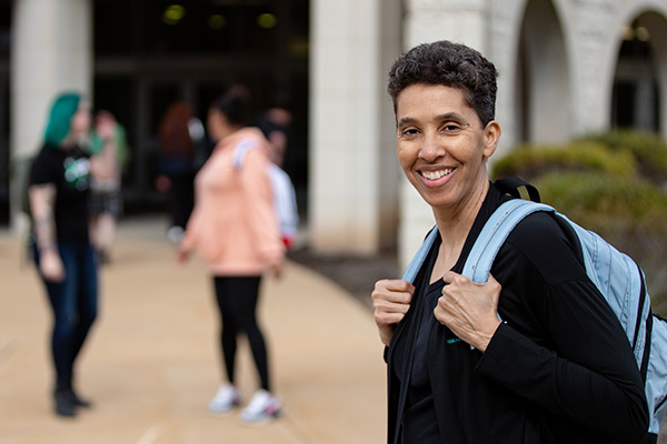 STLCC student with backpack outside on campus
